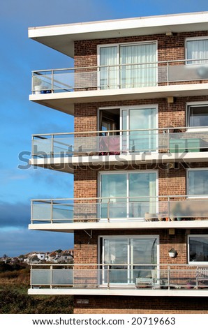 Old block of flats or apartments in England with sunny terraces