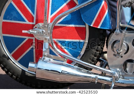 Custom chopper motorbike with chrome exhaust pipe and union jack wheel