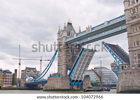 LONDON,UK-JUNE 1: The May a sprit sail barge built in 1891 sails under the raised Tower Bridge to take part in the Queen\'s diamond Jubilee Pageant on the Thames. June 1, 2012 in London UK.