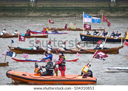 LONDON, UK-JUNE 3: Man powered boats including the Sgian Durh a Thames Skiff and the Bien Trouve a Moray Gig, row down the Thames in the Queen\'s Diamond Jubilee Pageant. June 3, 2012 in London UK