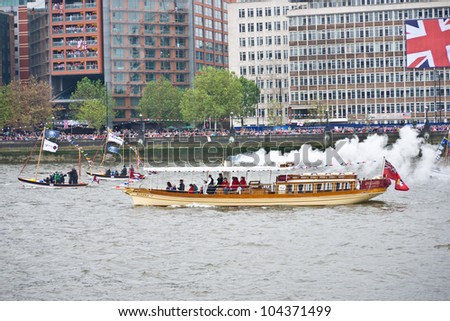 LONDON, UK-JUNE 3: The Alaska built in 1883 the oldest working passenger vessel on the Thames, blows steam as she takes part in the Queen\'s Diamond Jubilee pageant. June 3, 2012 in London UK