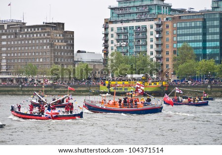 LONDON, UK-JUNE 3: Life Boats including the boat from Walton on the Naze, take part in the flotilla of a 1,000 ships for the Queen\'s Diamond Jubilee celebrations. June 3, 2012 in London UK.
