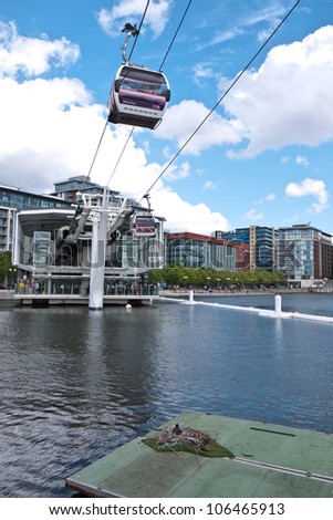 LONDON< UK-JUNE 30: A Coot nests under  Britain\'s first urban cable car route. The system called Emirates Air Line runs from the Royal Docks to the Greenwich peninsula June 30, 2012 in London UK.