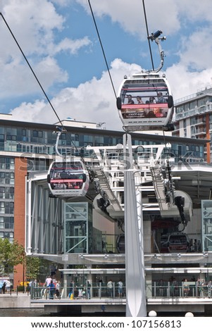 LONDON, UK-JUNE 30:Visitors travel on Emirates Air Line cable cars. The service is the UK\'s first urban cable car running across the Thames from the O2 to the Excel centre  June 30, 2012 in London UK