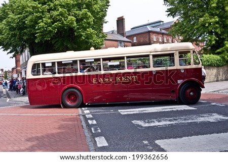FAVERSHAM, UK-MAY 17: Visitors enjoy the Vintage buses and coaches on display and taking passengers on rides as part of Faversham\'s Transport weekend. May 17, 2014 in Faversham  Kent, UK.