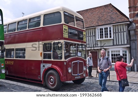 FAVERSHAM, UK-MAY 17: Visitors enjoy the Vintage buses and coaches on display and taking passengers on rides as part of Faversham\'s Transport weekend. May 17, 2014 in Faversham  Kent, UK.