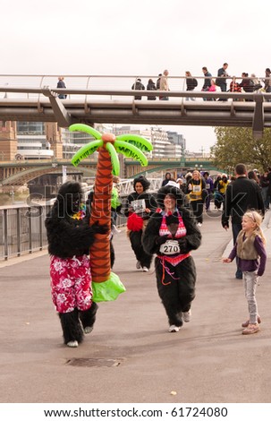 LONDON, UK- SEPTEMBER 26: A Competitor Dressed As A Hawaiian Gorilla With A Palm Tree Leads A Group Of Gorillas, London, September, 26 2010