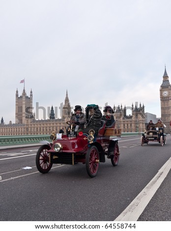 LONDON, UK - NOVEMBER 7: Vintage Car with Passengers in Historical Costume Cross Westminster Bridge on the London to Brighton Run. London, November, 7 2010.