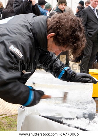 LONDON, UK - JANUARY 15: Close Up of one of the Ice Sculptors at Work at the Annual London Ice Sculpture Festival, Canary Wharf. London, January, 15 2010