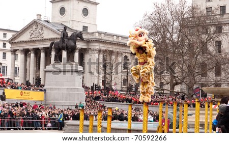 LONDON, UK-FEBRUARY 6: Acrobatic Lion Dancers leap across the poles in Trafalgar Square, during the annual Chinese New Year Celebrations. February 6,2011 in London, UK.