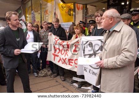 LONDON, UK - MARCH 26: actor Timothy West, reads a play, The Banker and His Son, outside the BHS store in Oxford Street, during a day of action against government cuts on March 26, 2011 in London, UK.