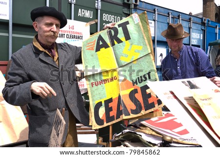 LONDON, UK-JUNE 19: International artist and cult figure, Billy Childish, selling work at the Annual Art Car Boot Fair in London\'s East End on  June 19, 2011 in London UK
