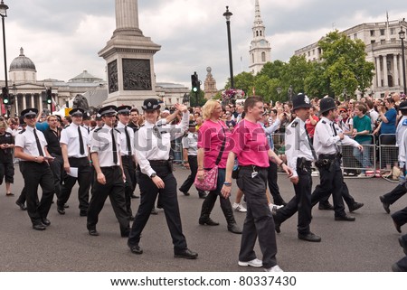 LONDON, UK-JULY 2: Members of the police force march past Trafalgar Square with the crowd cheering them on, in the annual London Gay Pride Parade. July 2, 2011 in London UK.