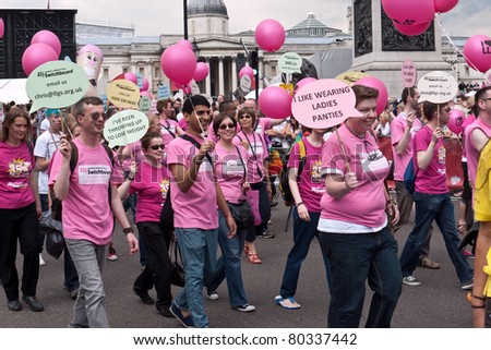 LONDON, UK- JULY 2: Members of the London, Lesbian and Gay Switch Board dressed in pink tops,with balloons and signs marching in the Annual London Gay Pride Parade. JUly 2, 2011 in London UK.