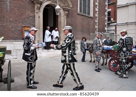 LONDON, UK-SEPTEMBER 25: Unidentified men participate in the Old English custom of the Pearly Kings and Queens delivering harvest festival offerings from their donkey carts to St Mary-le Bow Church on September 25, 2011 in London, UK.