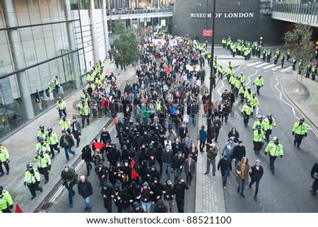 LONDON, UK-NOVEMBER 9: Students, surrounded by hundreds of police, march and carry banners in protest against fee increases and cuts to budgets at London Wall on November 9, 2011 in London UK.