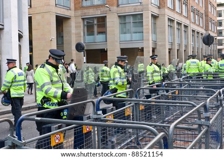 LONDON, UK-NOVEMBER 9: Police, fearing violence, man the barriers to London\'s Stock Exchange before the student march against cuts and increases in student fees on November 9, 2011 in London UK
