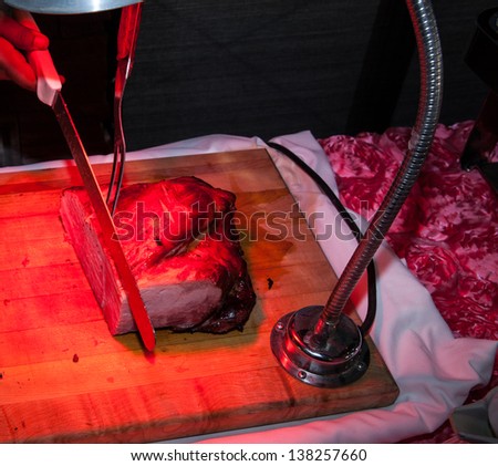 Carving Table with a Red Heat Lamp Warming the Meat