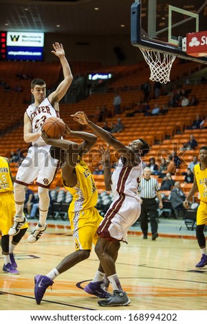 EL PASO, TEXAS - DECEMBER 28.  DenverÃ¢Â?Â?s Bret Olson (23) in the air trying to block Alcon State\'s Marquis Vance (30) shot in the Invitational Tournament on December 28, 2013 in El Paso, Texas.