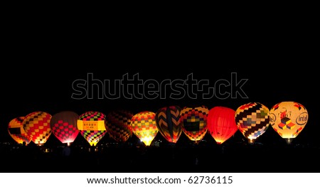 ALBUQUERQUE - OCTOBER 10.  Balloons are inflated and glowing  during the Dawn Patrol Show at the Albuquerque International Balloon Fiesta on the morning of October 10, at Albuquerque, NM