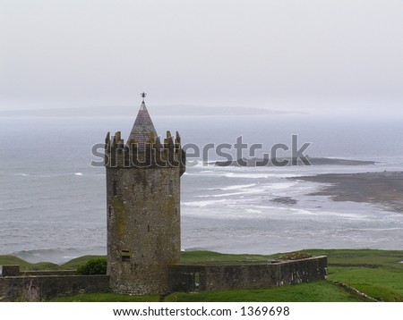 Irish castle and misty seashore. Doolin, County Clare, Ireland.