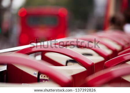 Red seats of open top sightseeing bus