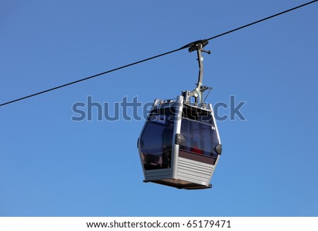 Cabin of a gondola lift climbing on its steel cable