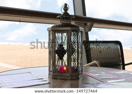A candle in a decorative candlestick at the beach cafe. Den Haag. Netherlands.