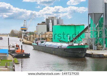 Ship in harbor of the cement plant. Netherlands