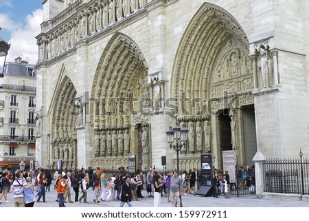 PARIS, FRANCE - JULY 10: Tourists near Notre Dame de Paris on July 10, 2012 in Paris, France