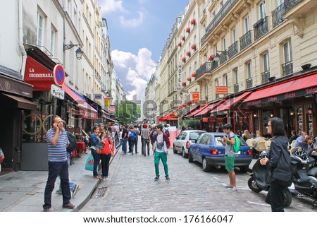 PARIS, FRANCE - JULY 10, 2012: People on the streets  in Paris, France. Paris is one of the most attractive tourist cities in the world