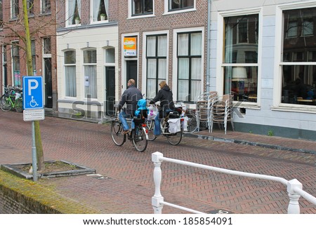 DELFT, THE NETHERLANDS - APRIL 7, 2012 : Family bike rides on the morning of the city  in Delft. Netherlands