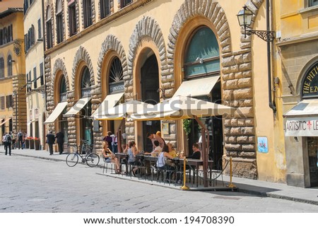 FLORENCE, ITALY - MAY 08, 2014: Tourists at an outdoor cafe in Florence. Italy
