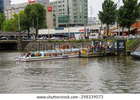 Amsterdam, Netherlands - June 20, 2015: People on the dock landing on river cruise ships, Amsterdam, Netherlands
