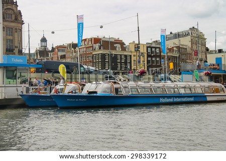 Amsterdam, Netherlands - June 20, 2015: People on the dock landing on river cruise ships, Amsterdam, Netherlands