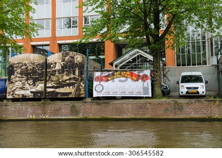 Amsterdam, Netherlands - June 20, 2015: Trade booths on the market Waterlooplein decorated historical photos. Amsterdam