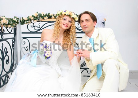 stock photo Young couple posing in a studio on the wedding day