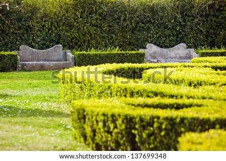 Old stone benches and shrub labyrinth, Jardim do Ultramar (Tropical Botanical Garden), Belem, Lisbon, Portugal