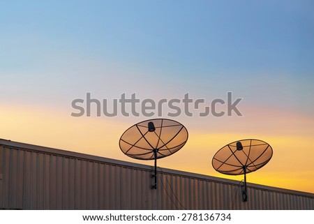 Satellite dishes antenna on the roof at sunset
