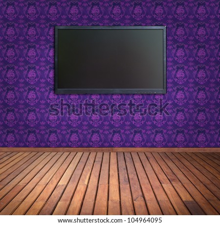 wide screen television in  purple wallpaper room