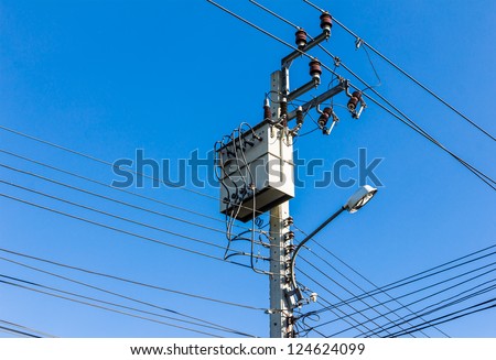 electricity high voltage transformer against blue sky