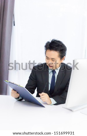 business man working with notepad and desktop computer