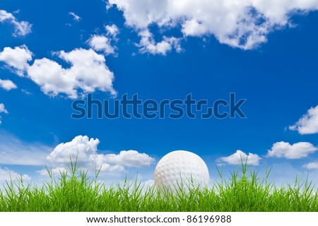 golf ball on green grass against blue sky