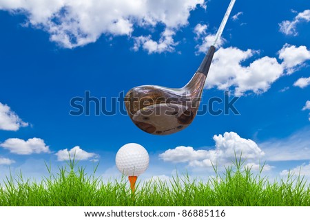 golf ball and driver on green grass