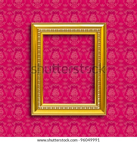 frame of golden wood  on red wallpaper
