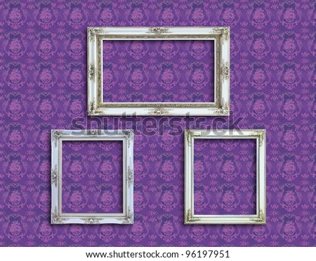 frame of white wood  on purple wallpaper