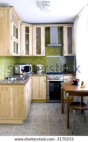Kitchen - natural wood cabinets with glass and stone tiles