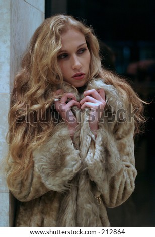 Cold girl waiting in a fur coat...