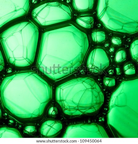 Close to life Description: Soap bubbles on green water