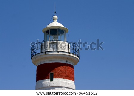 White and red lighthouse - The tower and it`s light of the red and white lighthouse on cape Ostro in Kraljevica